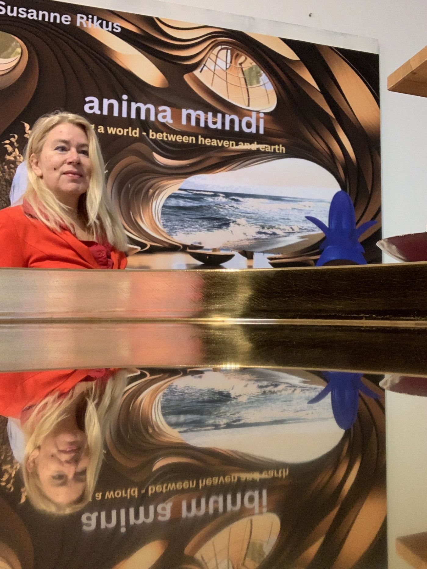 Susanne Rikus beside her work anima mundi in the gallery